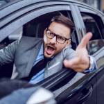 A sharp dressed man finding himself caught in a rush hour and slowly succumbing to road rage.