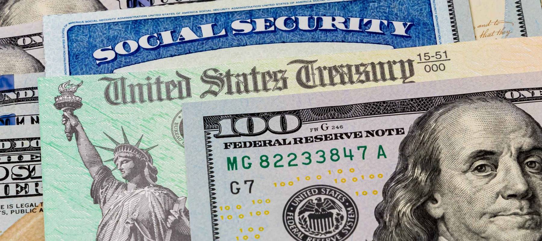 Social Security card, treasury check and 100 dollar bills. Concept of social security benefits payment, retirement and federal government benefits
