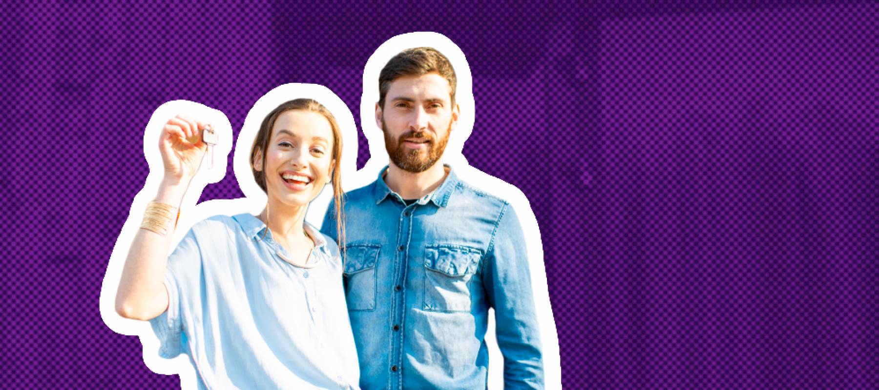 Happy young couple poses in front of a home, holding keys and smiling.