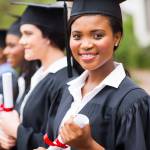 pretty african female college graduate at graduation with classmates