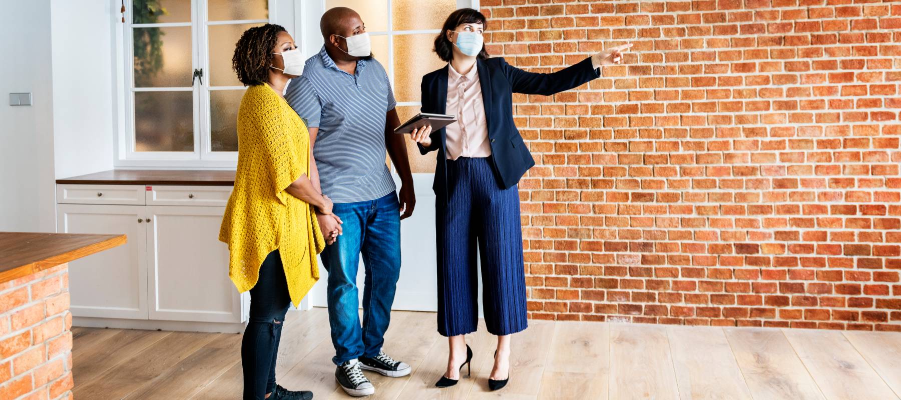 A couple touring a house for sale with their real estate agent