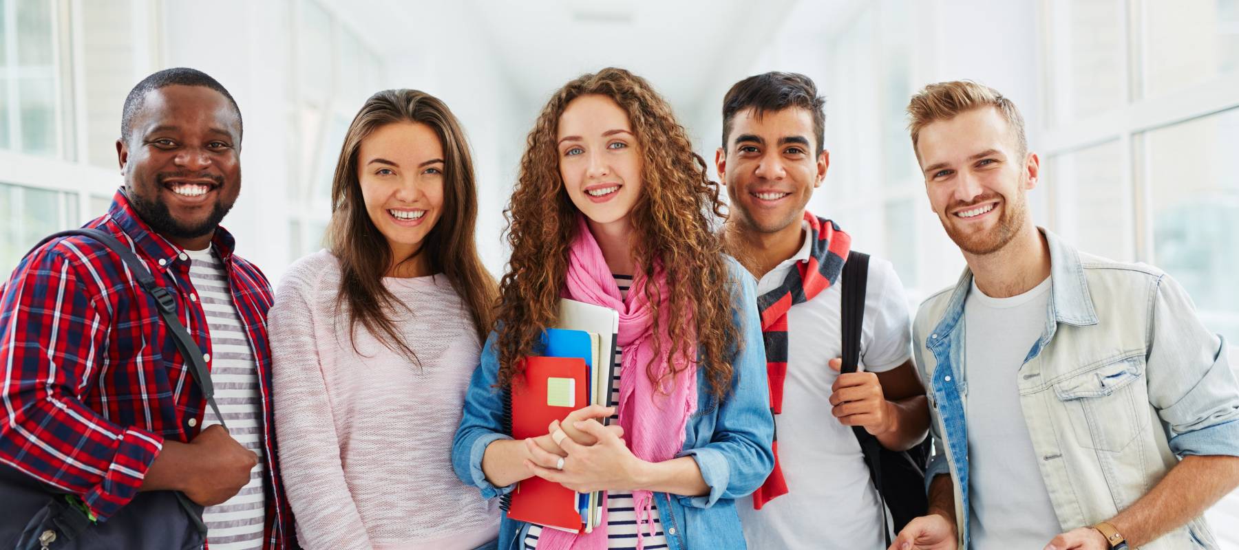 Happy college students looking at camera with smiles