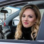 Woman looks out car window