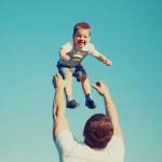Vintage colors photo happy father and child having fun outdoors, carefree, blue sky, family, travel, vacation, childhood, father's day - concept