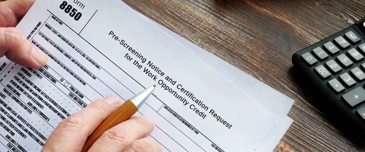 Hand filling out form for Work Opportunity Tax Credit
