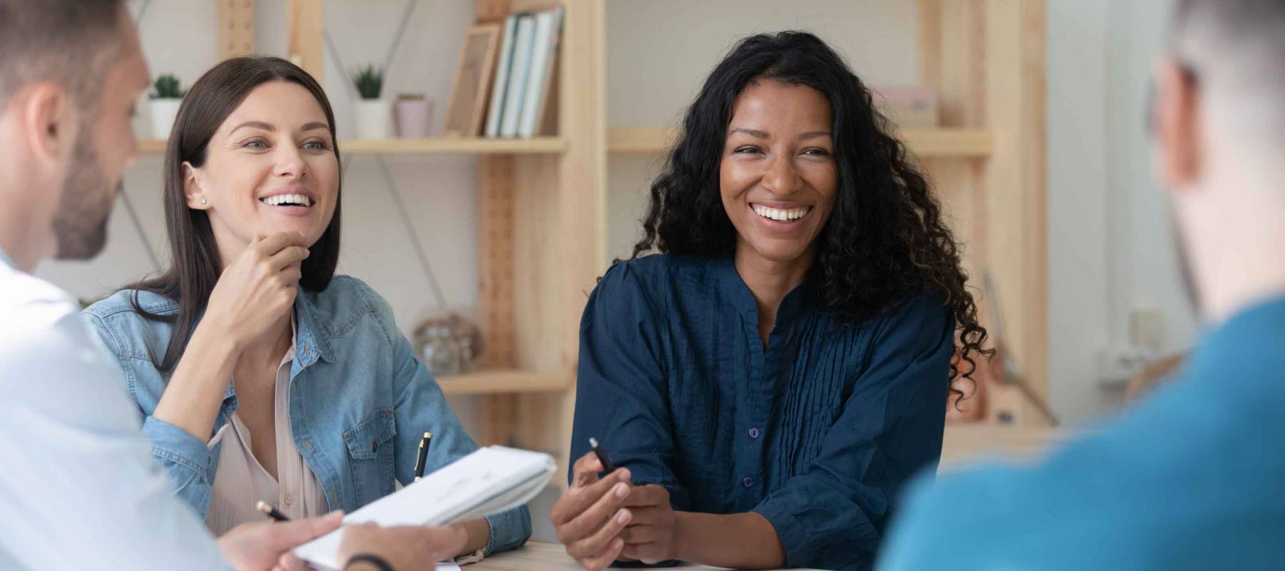 Happy african american businesswoman telling employees about work benefits
