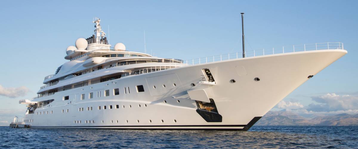 Gigantic big and large luxury mega or super motor yacht on the ocean.
