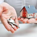Real estate agent with house model and keys
