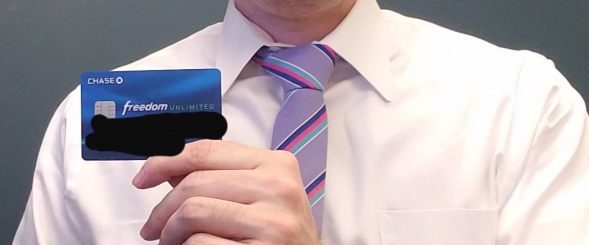 How A Money Expert Beat His Embarrassing Credit Card Debt - mark durrenberger holding one of the cards he still uses with the numbers blacked