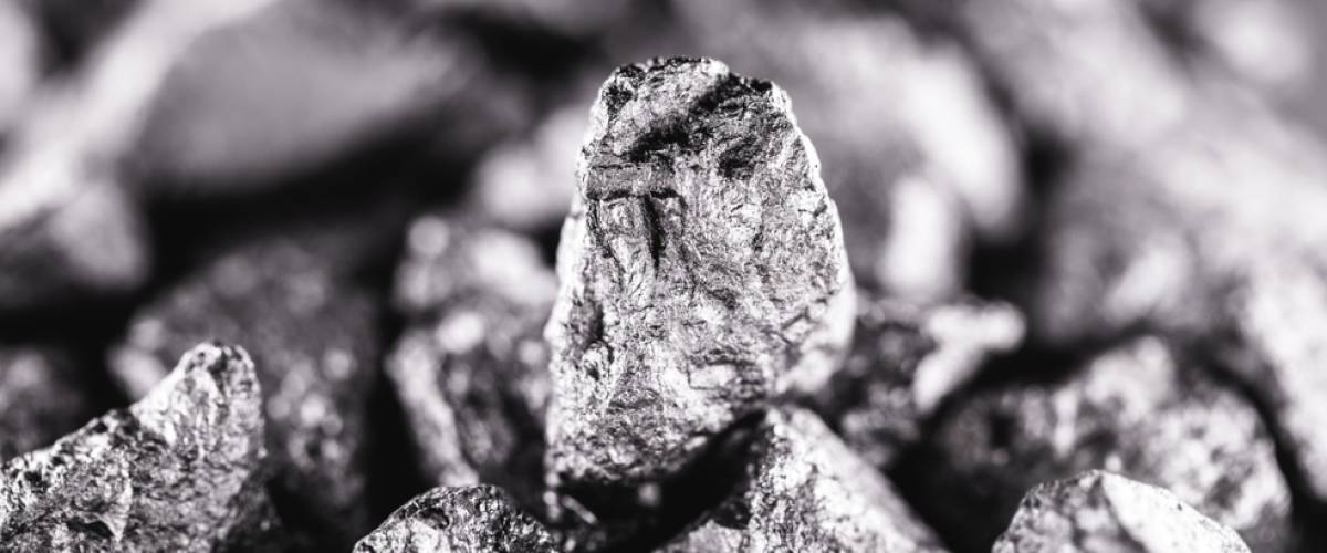 big silver nugget on black background. Raw silver stone, native silver nugget from Liberia, isolated on black background.