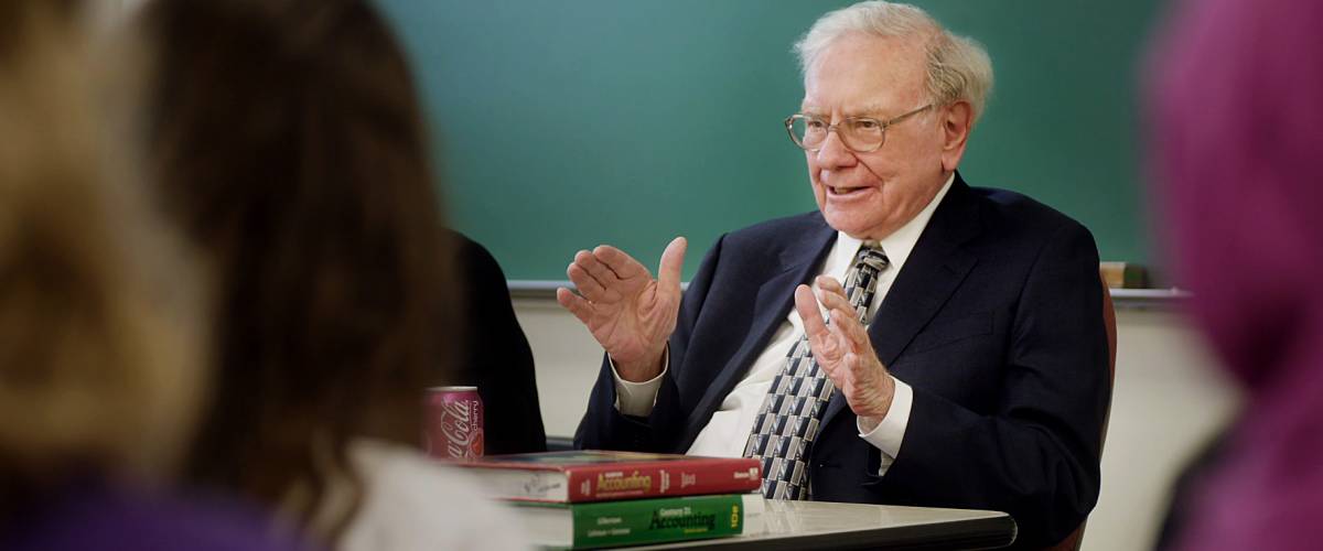 Warren Buffett addresses a classroom of students.
