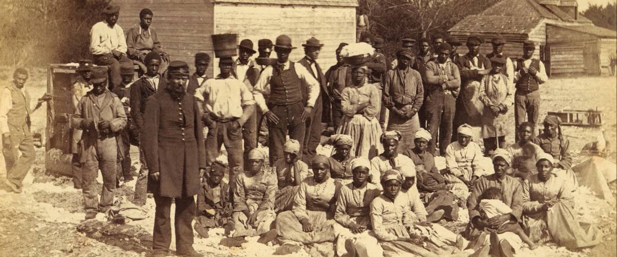 A Union soldier stands with African Americans on the plantation Thomas F. Drayton, Hilton Head Island, South Carolina, 1862. Photo by Henry P. Moore, May 1862.