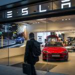 Barcelona, Spain. March 2018: Tesla inc cars flagship store near Passeig de Gracia luxury shopping street with Tesla logo and an electric cars model S and X inside