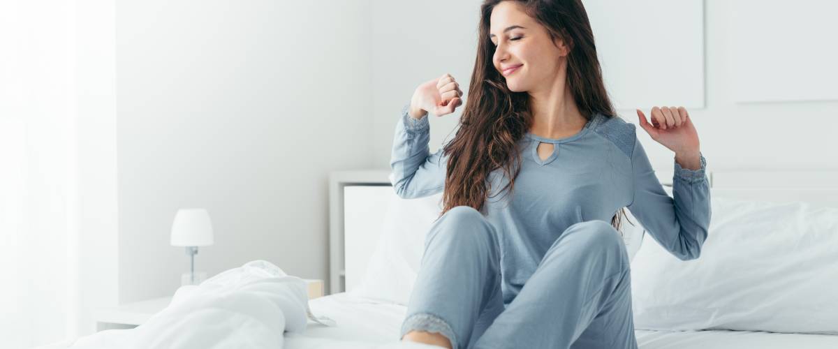 Woman waking up and stretching