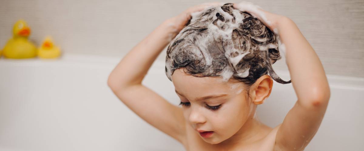 Child in bath with soapy hair