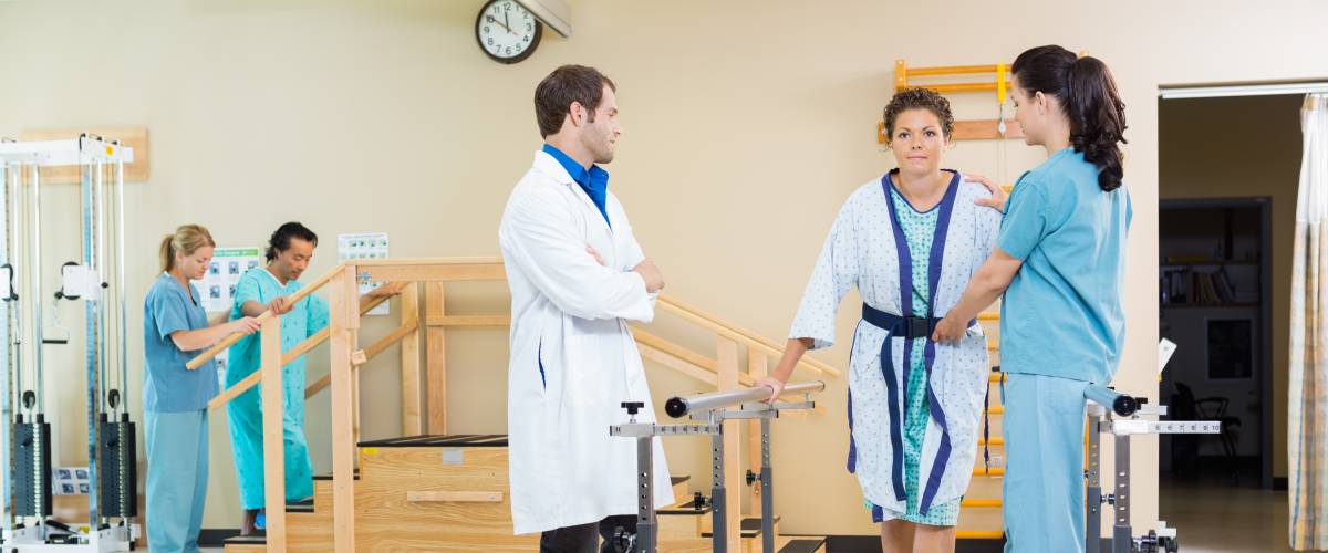 Physicians assisting client with physical rehabilitation counseling