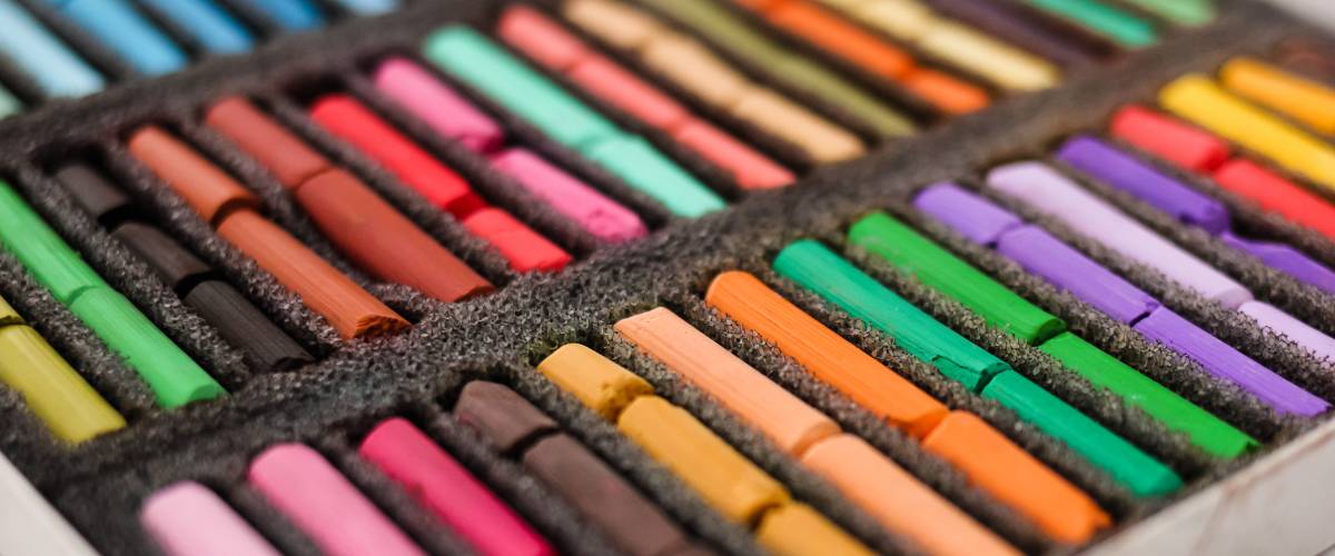 multi-colored chalk in a tray