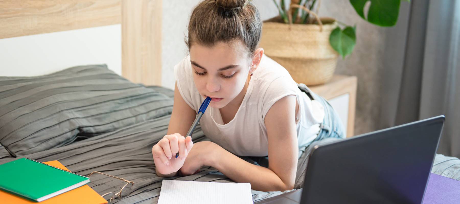 Teen girl uses laptop at home.