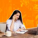 Authentic portrait of young stylish woman working online on laptop in modern cafe