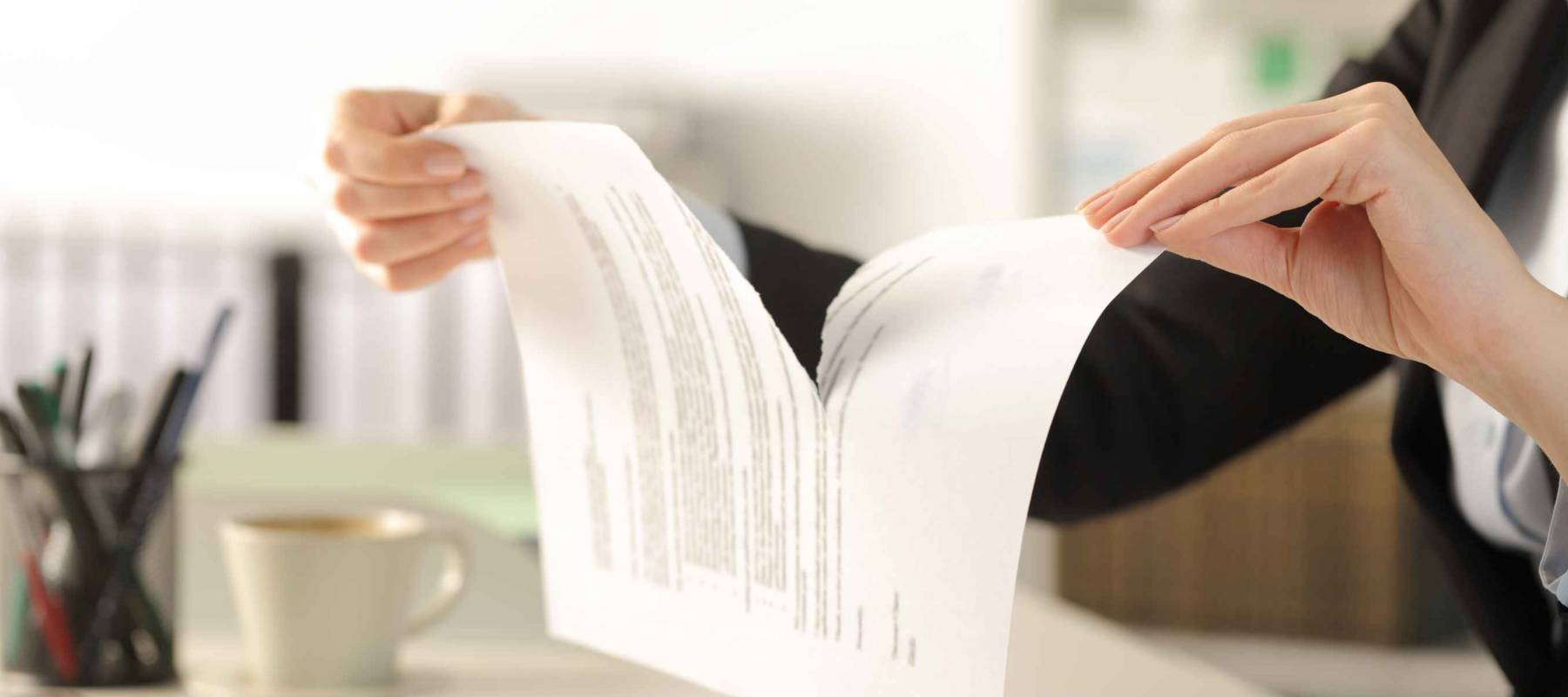 Close up of business woman hands breaking contract