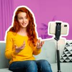 Portrait of beautiful cheerful redhead girl with headsets have video call.