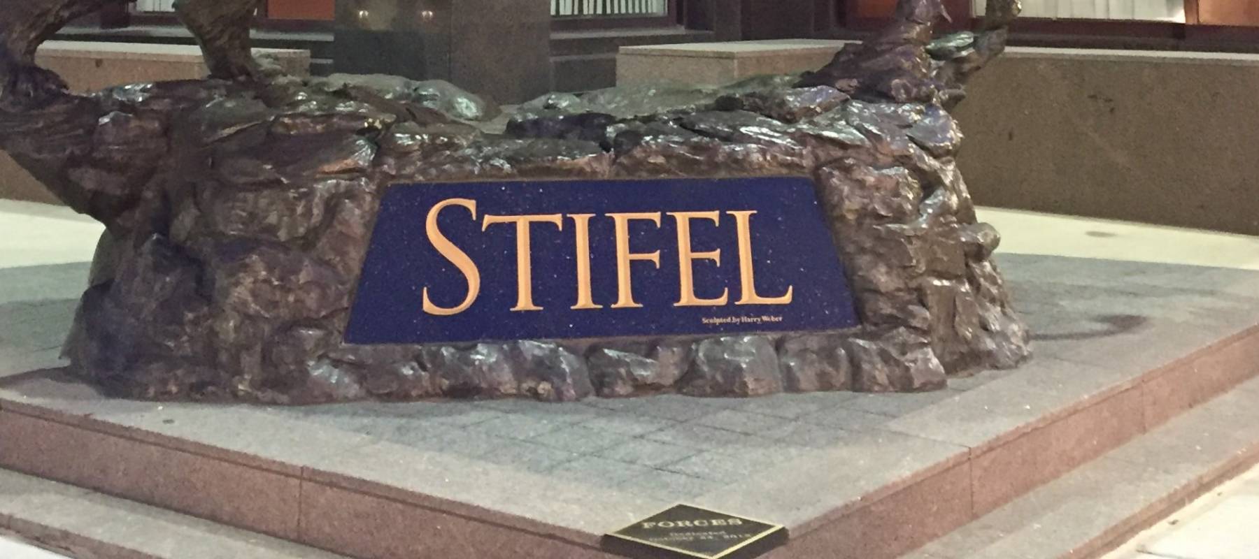 Sculptures symbolizing stock market bull and bear compete at national headquarters of brokerage and investment banking firm Stifel