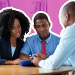 A couple looks at home loan paperwork with their mortgage broker