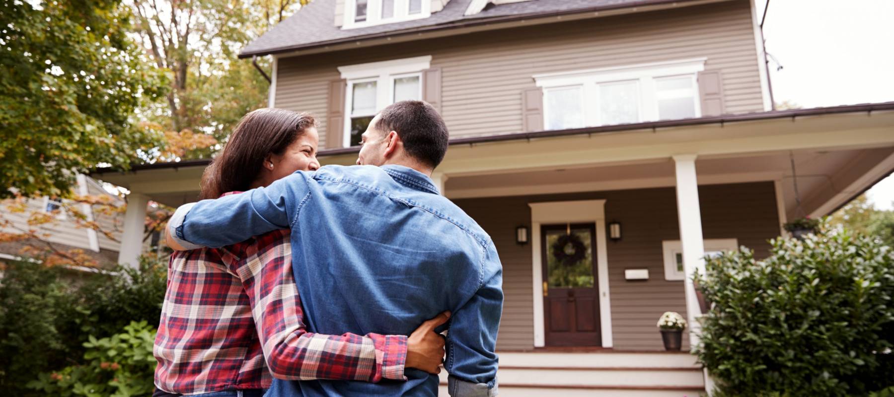 Rear View Of Loving Couple Walking Towards House