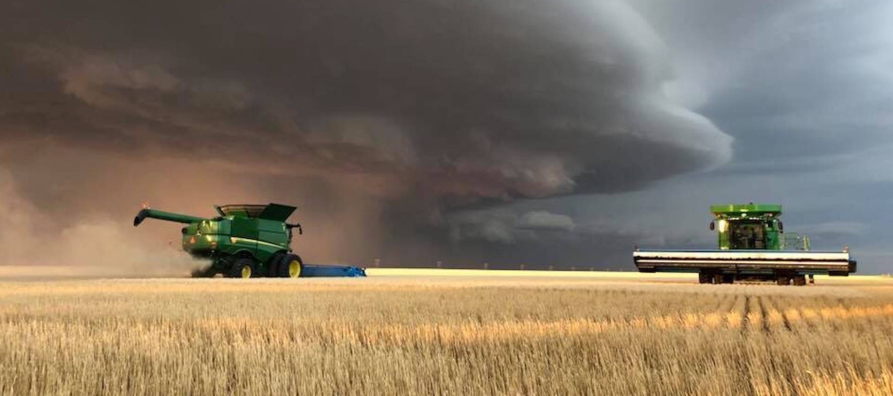 Farming with storm in distance