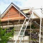 Outside renovation of modern residential house, scaffolding tower