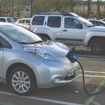 Woman charging electric car