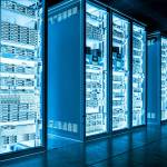 Big data dark server room with bright blue equipment