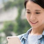 lady looking at the phone and smiling