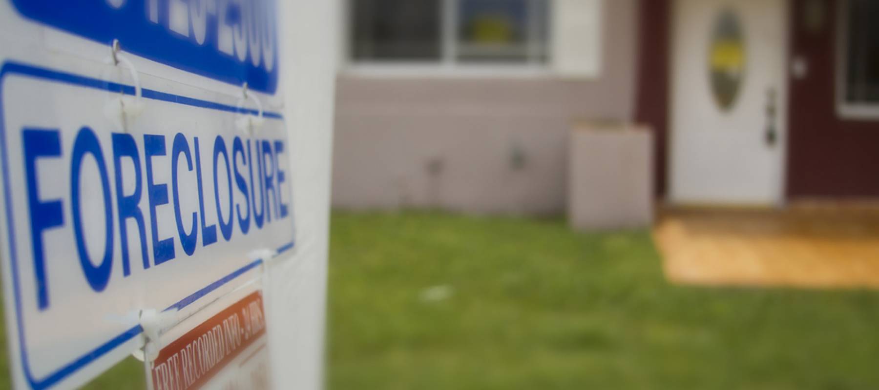A foreclosure sign outside of a condemned home.