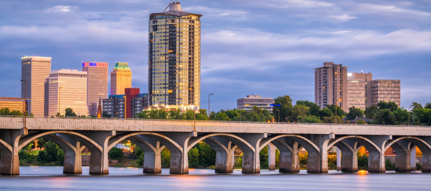 Tulsa, Oklahoma, USA downtown skyline on the Arkansas River at dusk.