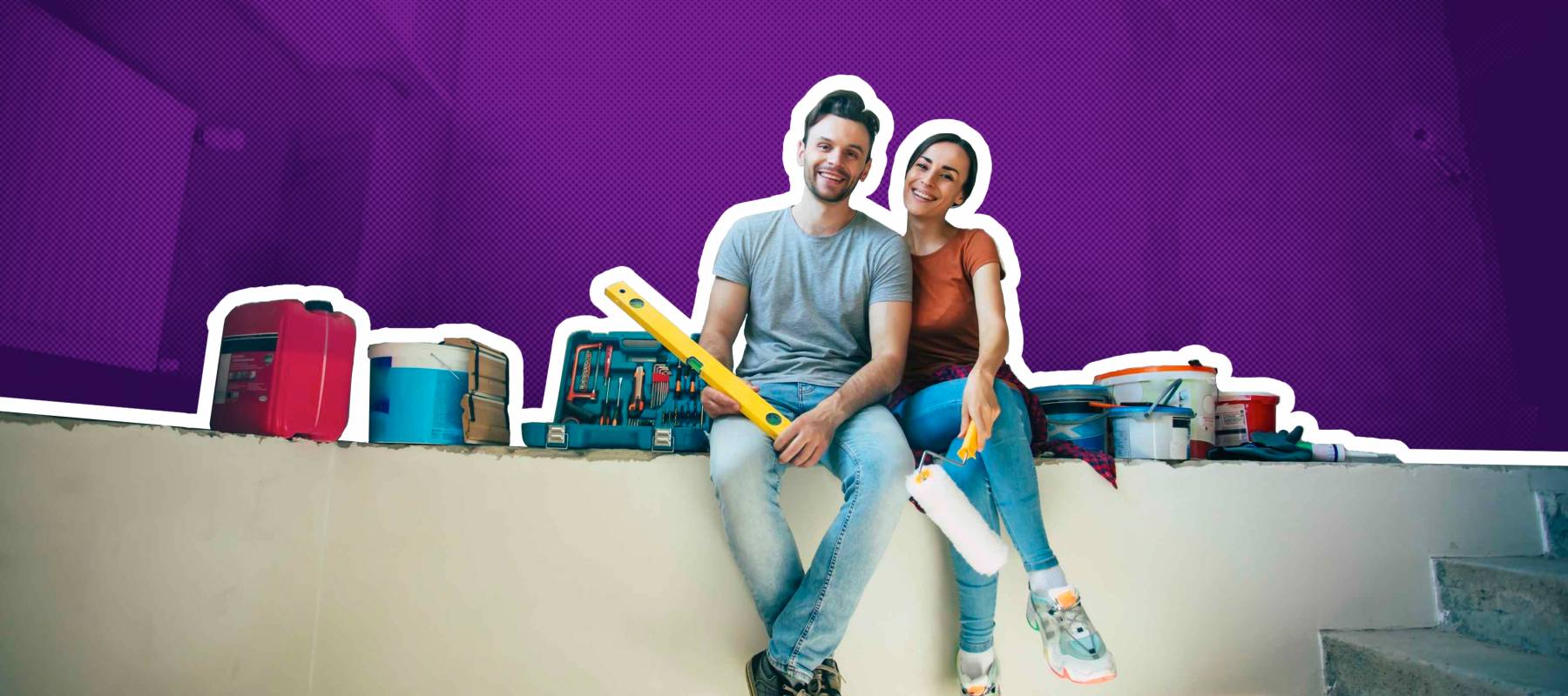 Modern happy young couple in love in casual clothes during new home repair or renovation of walls with a lot of tools for this