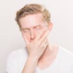 Man covering his mouth