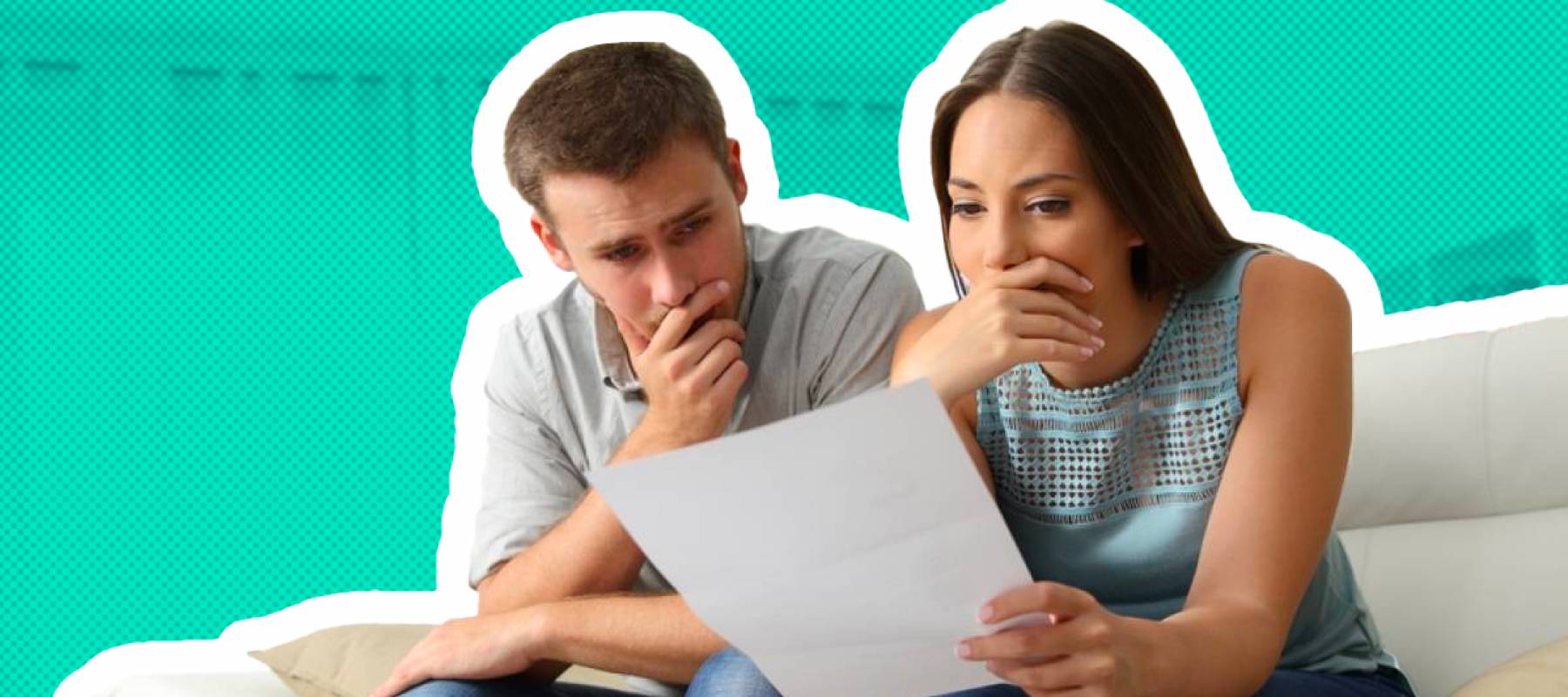 Worried couple reading a letter sitting on a couch in the living room at home
