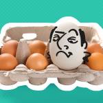 Smug looking egg with a cartoon face sits in an egg carton.