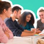 Group of students sit at a table looking at forms.
