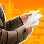 Man in grocery store looking at receipt