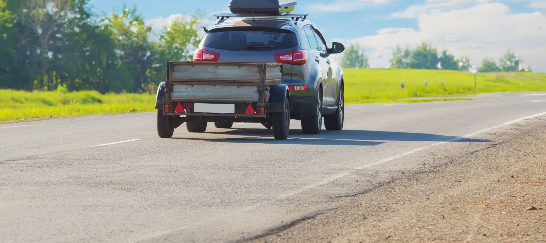 SUV with trailer goes on country highway