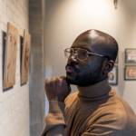 Man looking at paintings in museum