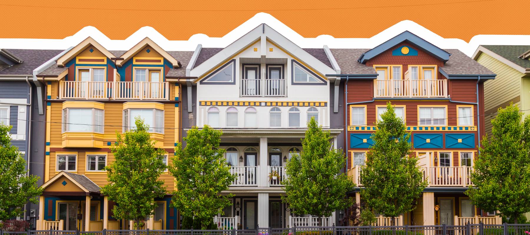 Different colored houses in The Beaches area of Toronto during the day.