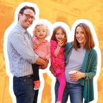 Parents holding young kids and posing smiling for the camera at a block party.