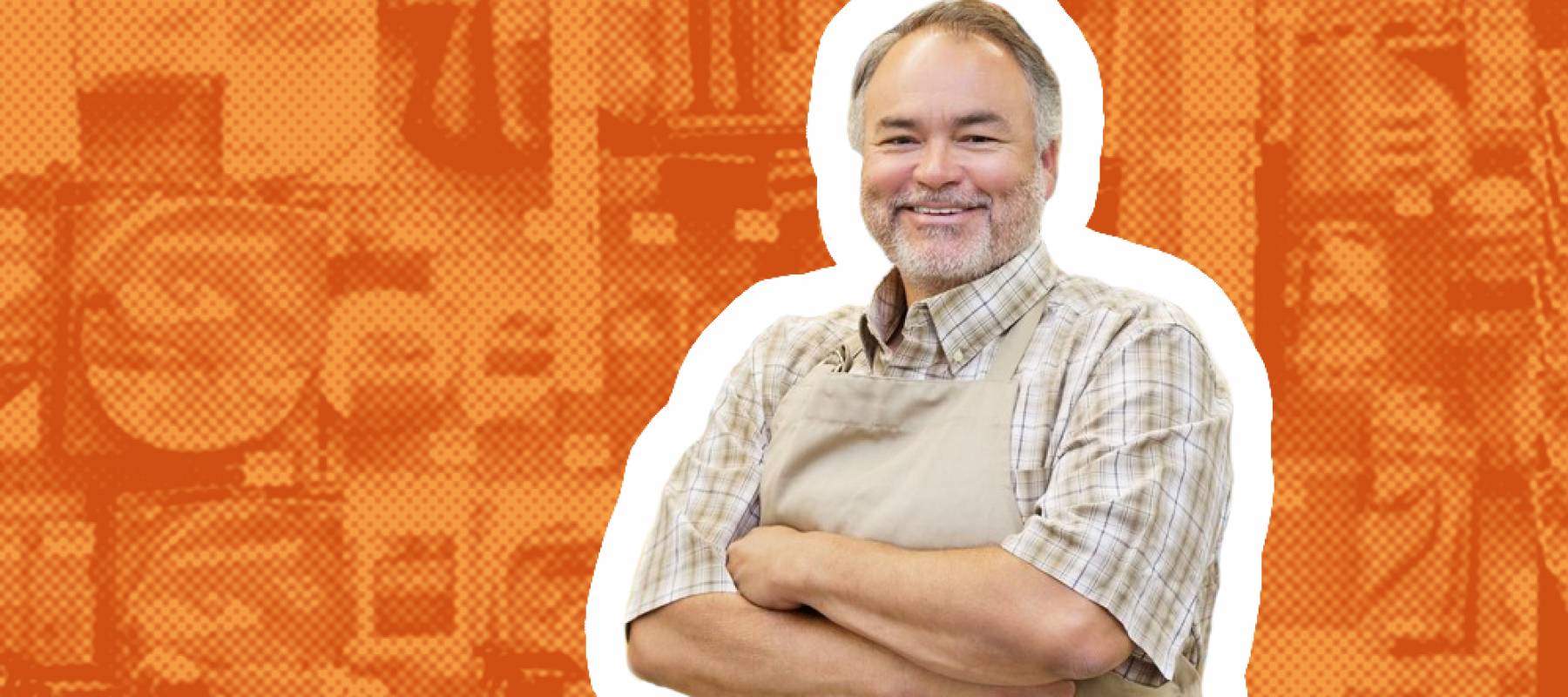 Portrait of a happy middle-aged salesperson with arms crossed in hardware store.