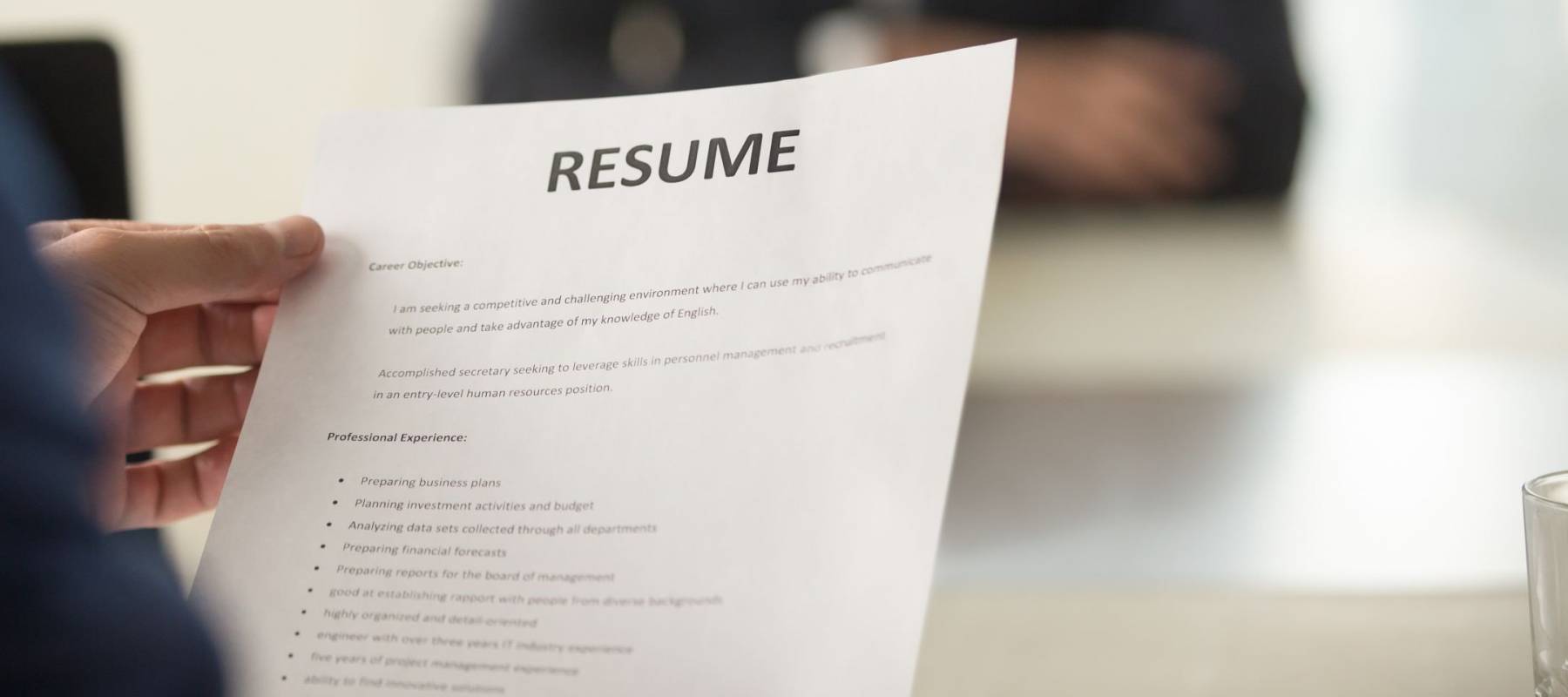 Close up view of job interview in office, focus on resume writing tips