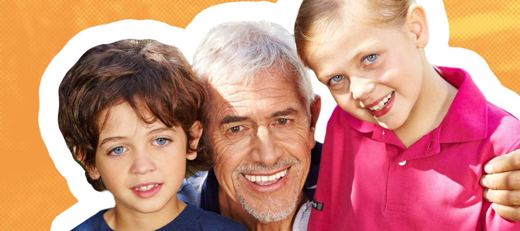 Happy grandfather poses with two young grandchildren, all smiling for the camera.