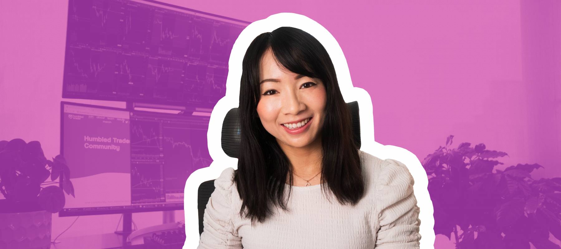 Shay Huang smiles and poses face on to the camera with her trading set up behind her: computer open.