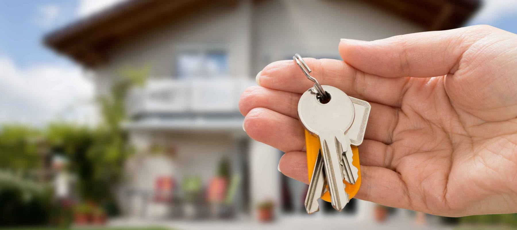 Close-up Of Person Hand Holding House Key In Hand